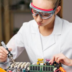 female-technician-with-soldering-iron-electronics-board_23-2148816358
