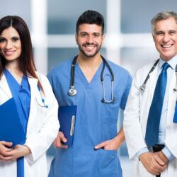 group-smiling-doctors-bright-blurred-background_53419-2616