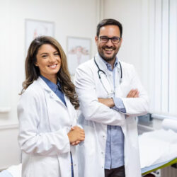 portrait-smiling-young-doctors-standing-together-portrait-medical-staff-inside-modern-hospital-smiling-camera_657921-885