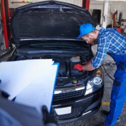 mechanics-repairing-car-workshop_329181-11824