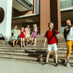 happy-kids-playing-city-s-street-sunny-summer-s-day-front-modern-building_155003-20908