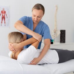 physiotherapist-helping-young-female-patient_23-2149115580